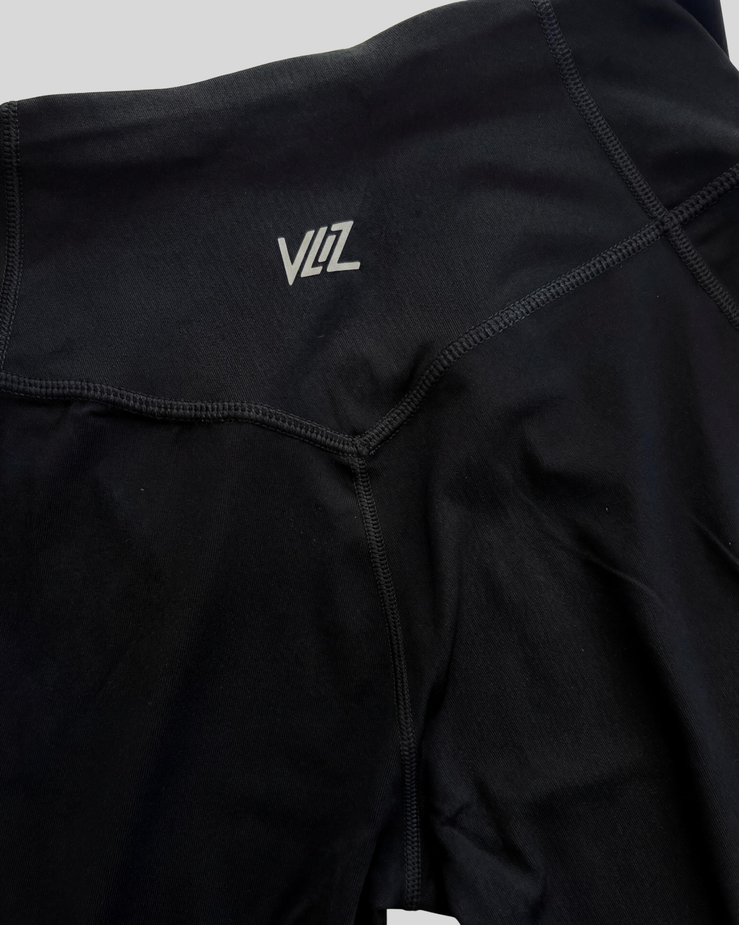 VLIZ AuraFlow Full-Length Leggings in black, laid flat on a white background. Features a V-shaped high-rise waistband with the VLIZ logo, designed for a sleek, supportive fit ideal for gym workouts, yoga, Pilates, and everyday training.