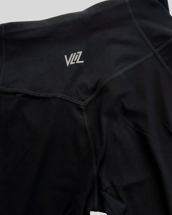 VLIZ AuraFlow Full-Length Leggings in black, laid flat on a white background. Features a V-shaped high-rise waistband with the VLIZ logo, designed for a sleek, supportive fit ideal for gym workouts, yoga, Pilates, and everyday training.