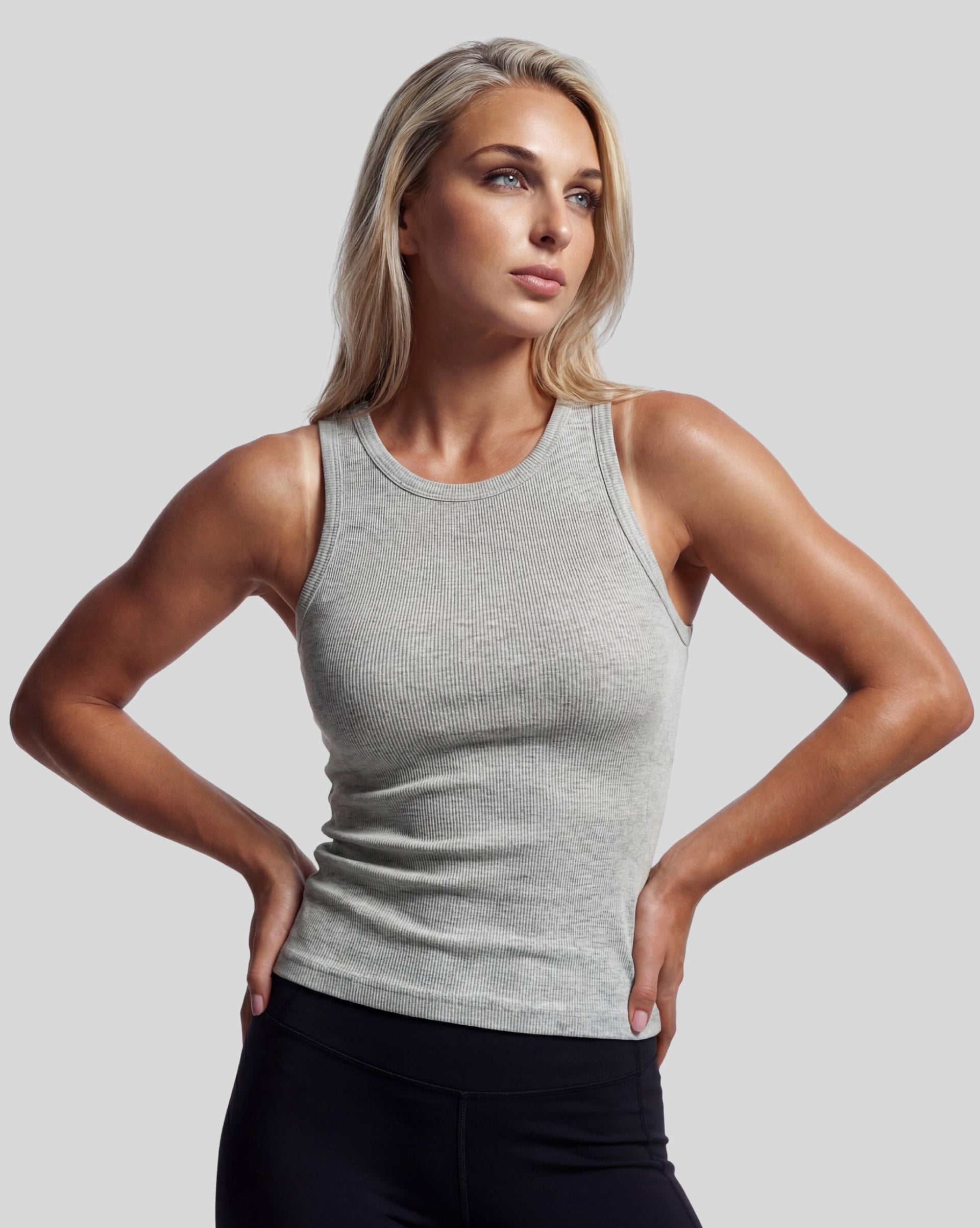 VLIZ Soft-Ribbed Padded Tank Top; a blonde woman models a light grey ribbed tank top with built-in pads and a supportive racerback design, paired with black leggings against a white background. Ideal for gym workouts, yoga, Pilates, and everyday training, highlighting its comfortable, flattering fit.
