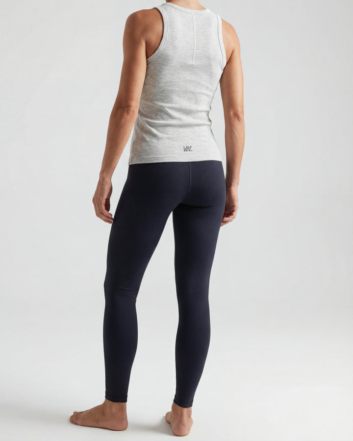 VLIZ Soft-Ribbed Padded Tank Top; a blonde woman models a light grey ribbed tank top with built-in pads and a supportive racerback design, paired with black leggings against a white background. Ideal for gym workouts, yoga, Pilates, and everyday training, highlighting its comfortable, flattering fit.