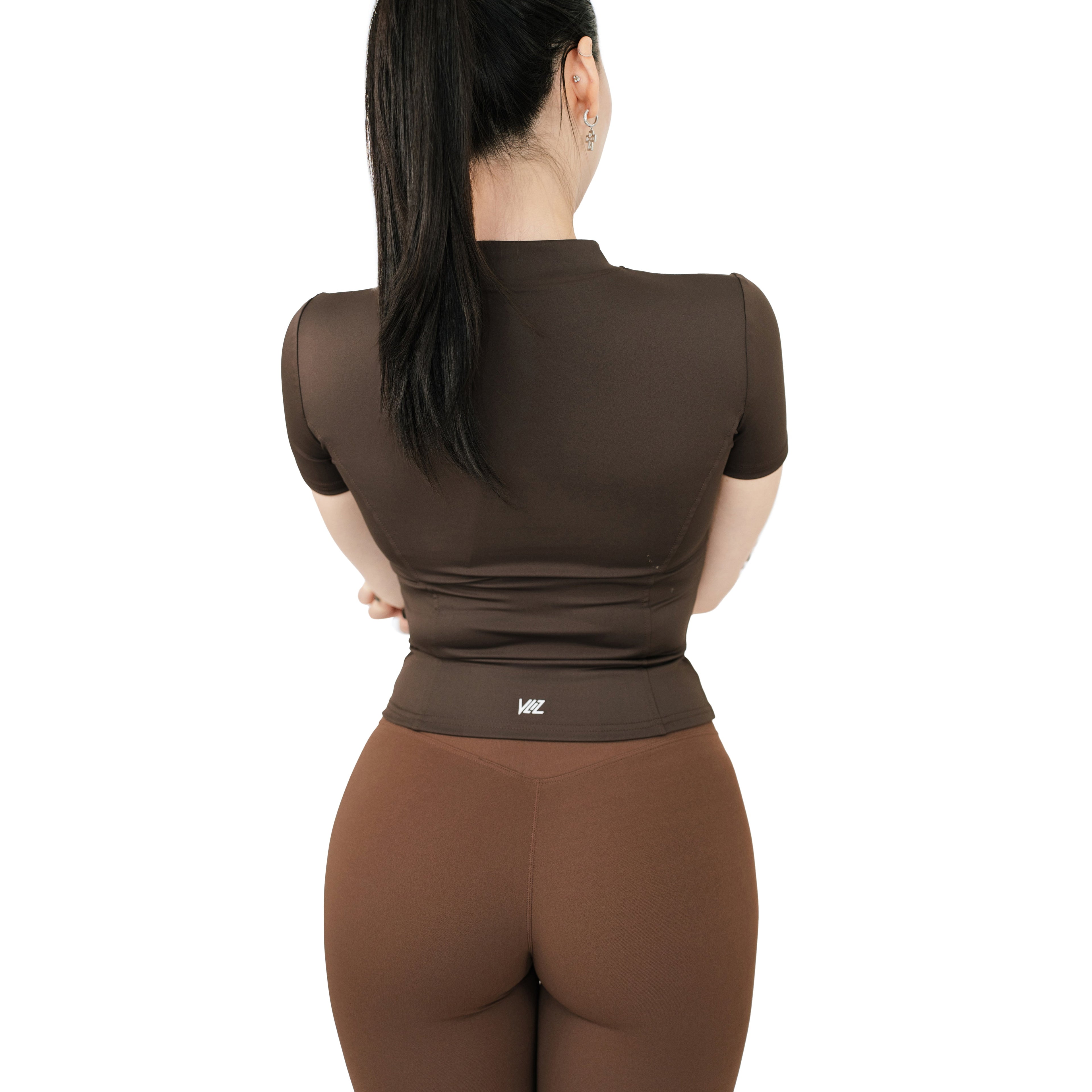 Back view of VLIZ Full-Zip SculptFit Short Sleeve Top in Espresso showing fitted structure and seamless back contour.