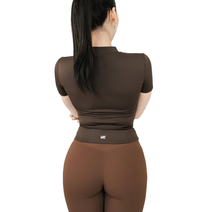 Back view of VLIZ Full-Zip SculptFit Short Sleeve Top in Espresso showing fitted structure and seamless back contour.