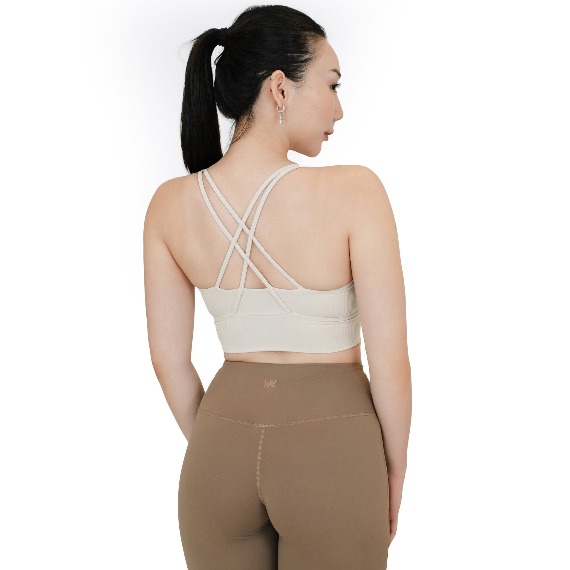 VLIZ ContourFlex Cross-Back Sports Bra in white shown from a back angle, featuring ribbed fabric and criss-cross strap detailing for added support and style.