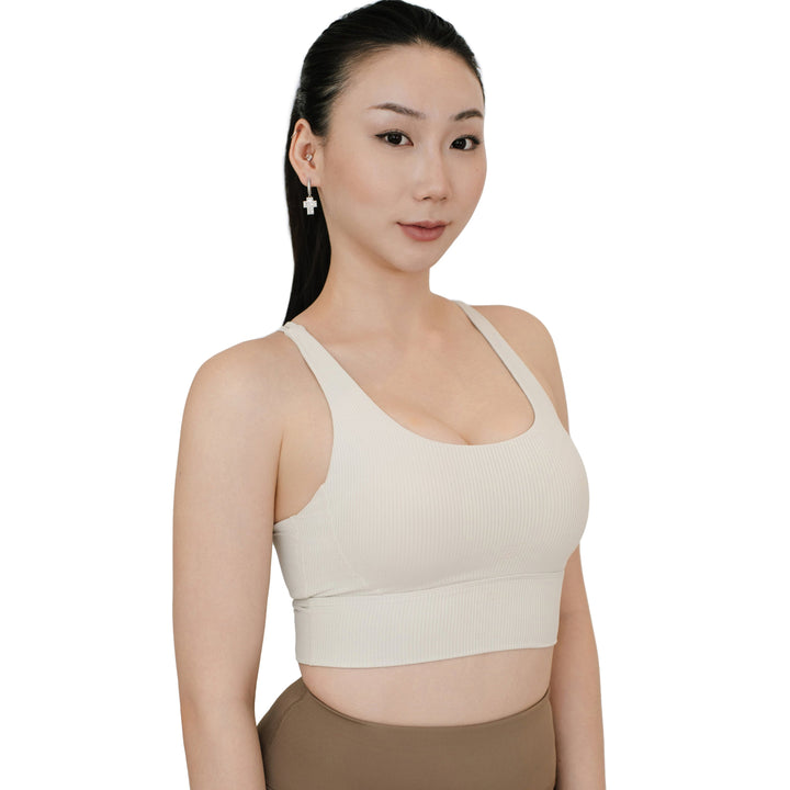 VLIZ ContourFlex Cross-Back Sports Bra in white shown from the front, featuring ribbed fabric, scoop neckline, and wide underband for support, ideally for yoga and training.