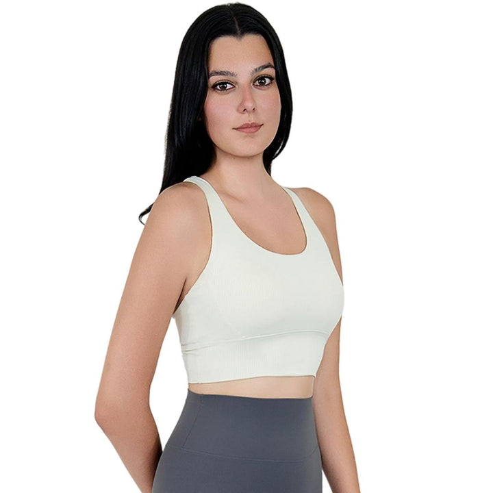 Model in VLIZ ContourFlex Cross-Back Sports Bra in White, featuring criss-cross back straps and a sculpting, supportive fit ideal for yoga, Pilates, cardio, tennis, and everyday active movement.
