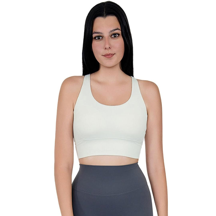 Model in VLIZ ContourFlex Cross-Back Sports Bra in White, featuring criss-cross back straps and a sculpting, supportive fit ideal for yoga, Pilates, cardio, tennis, and everyday active movement.