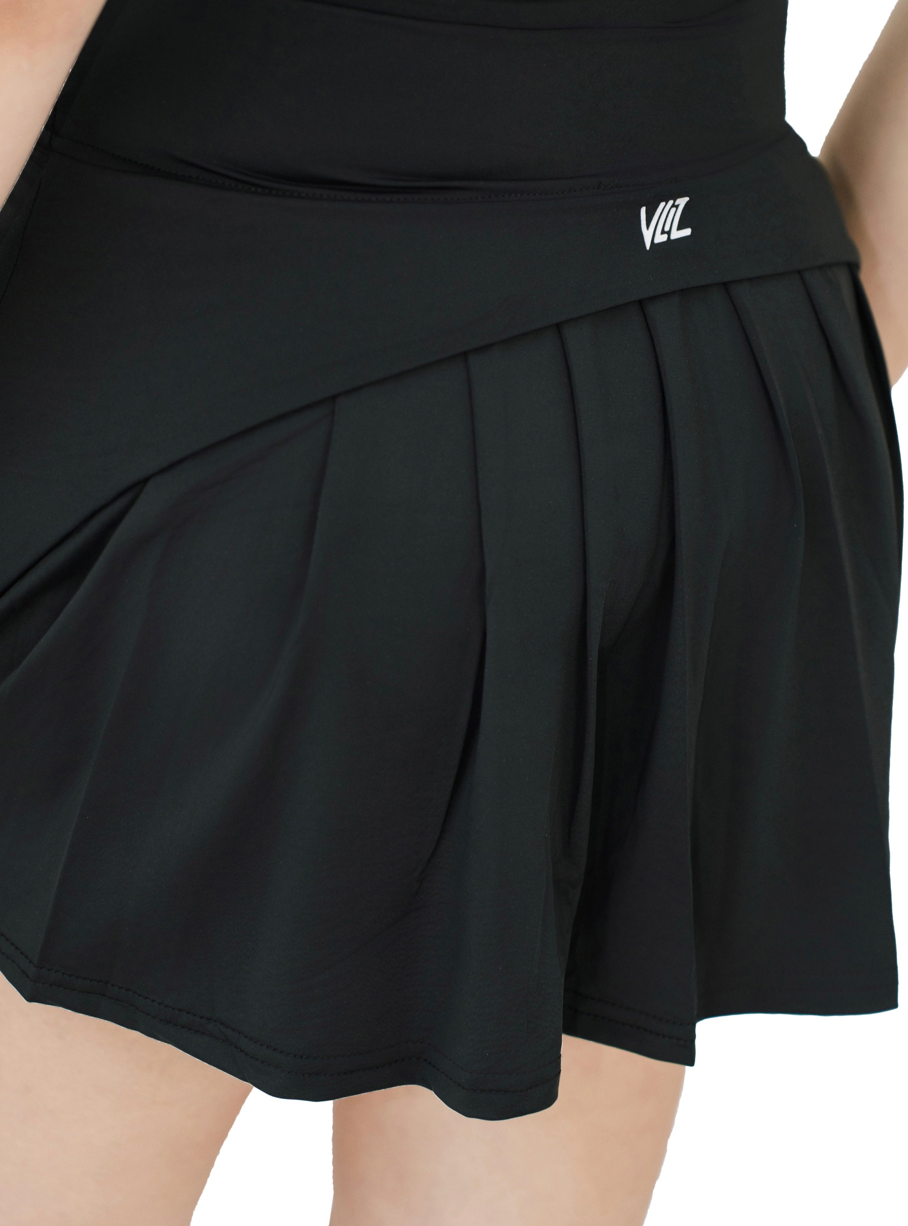 Back view of VLIZ ContourFlex Tennis Skirt in black, showcasing pleated skirt design and VLIZ logo on waistband.