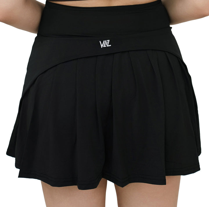 Center back view of VLIZ ContourFlex Tennis Skirt in black, highlighting pleated design and branded waistband.