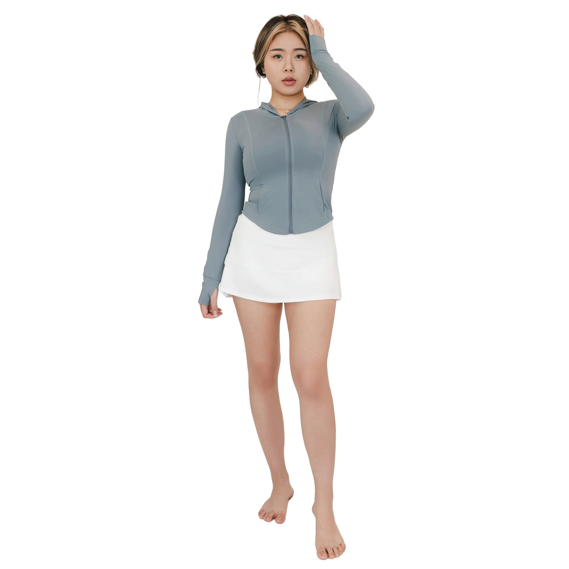 VLIZ ContourFlex High-Waist Tennis Skirt in white shown in full-body front view, paired with a fitted zip-up top.