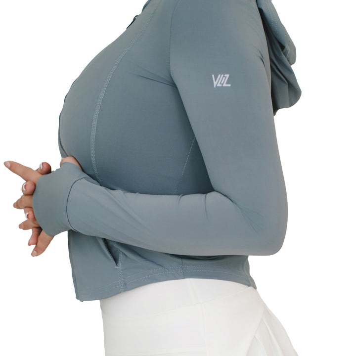 Close-up side view of VLIZ Rapid UV Full Zip SlimFit Hooded Top in Ash Gray, showing thumbhole cuffs and arm logo.