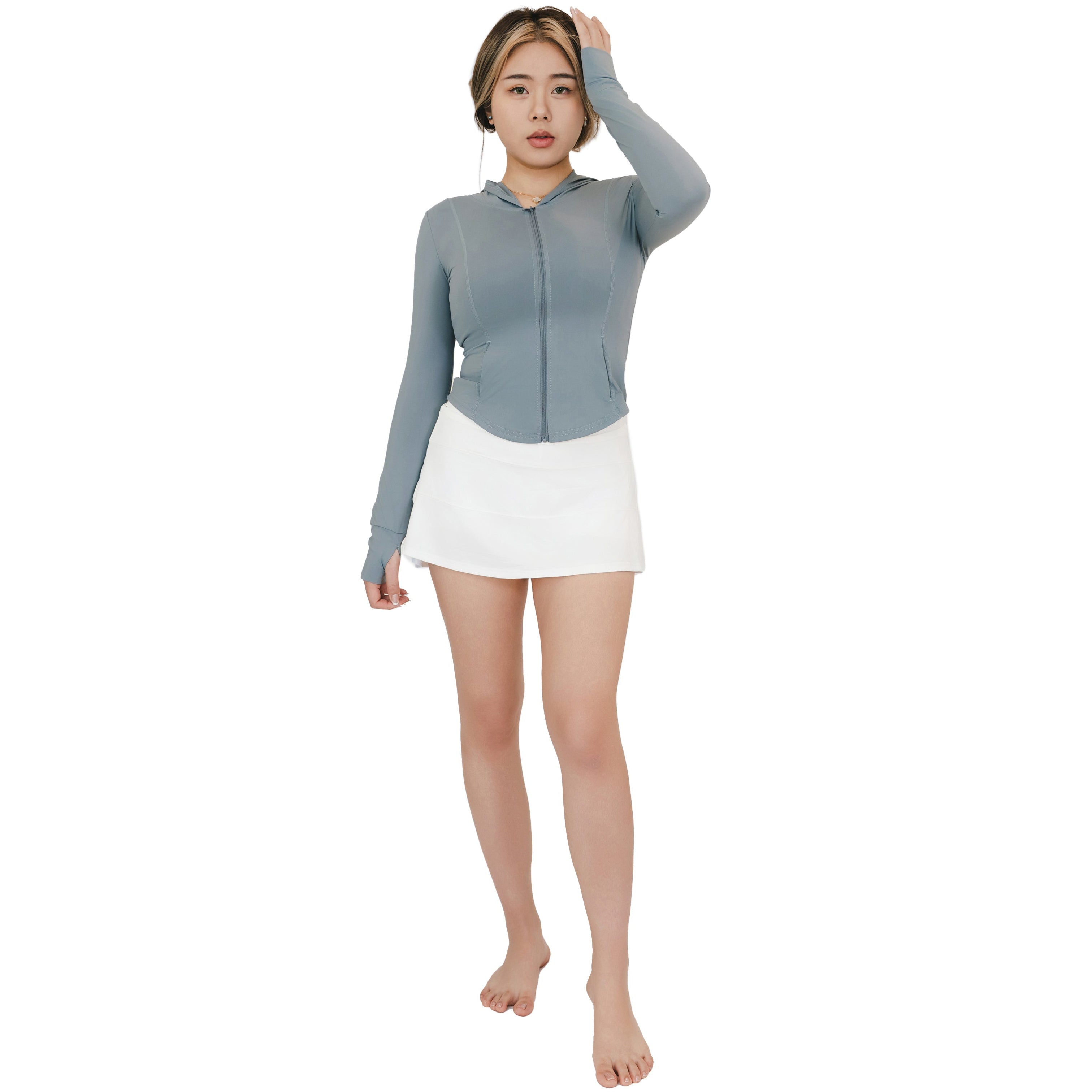 Model in VLIZ Rapid UV Full Zip SlimFit Hooded Top (Ash Gray) with hand touching hair, showing relaxed sporty outfit.