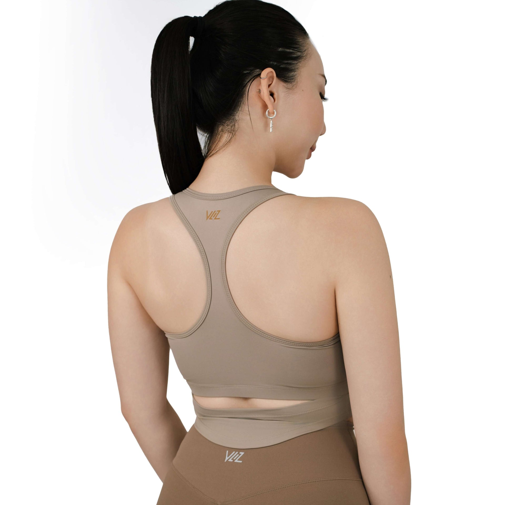 Back view of VLIZ SculptFit racerback sports bra in khaki, featuring a cut-out detail, sculpting fit, and tonal logo on the upper back.