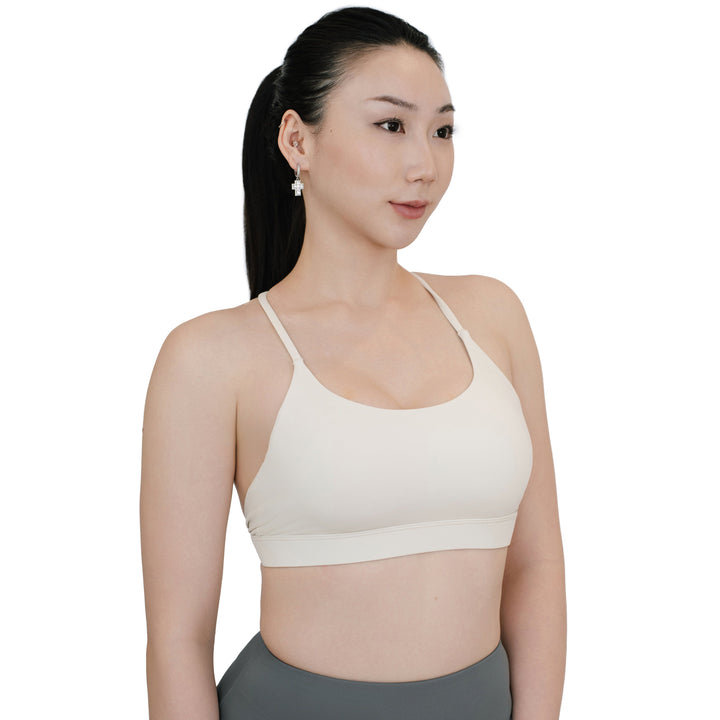 VLIZ SculptFlex Sports Bra in White featuring a scoop neckline and thin cross-back straps, offering a sleek silhouette and medium support.