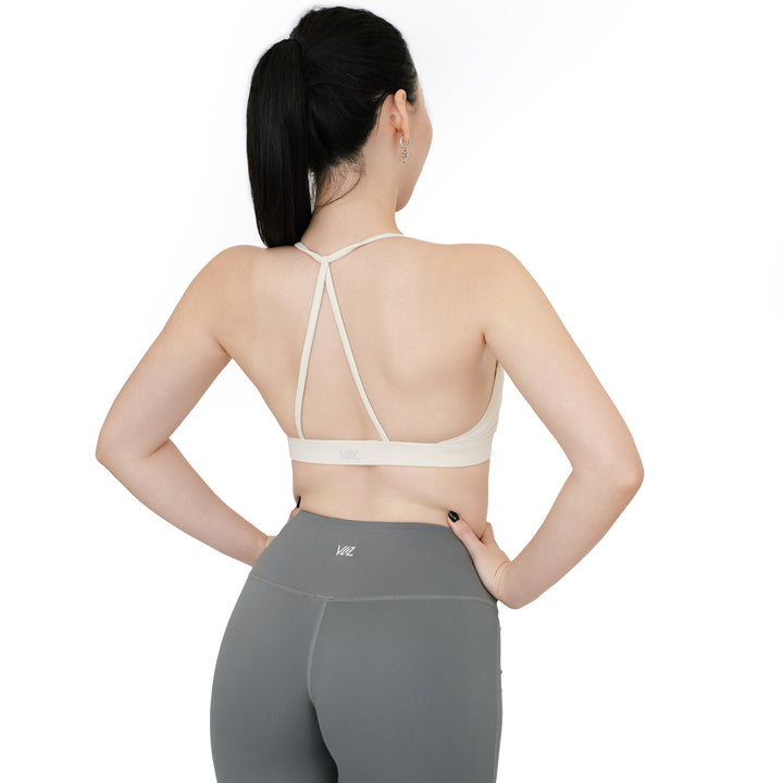 Back view of the VLIZ SculptFlex Sports Bra in White, highlighting the Y-shaped minimalist strap design and supportive underband for flexible movement.