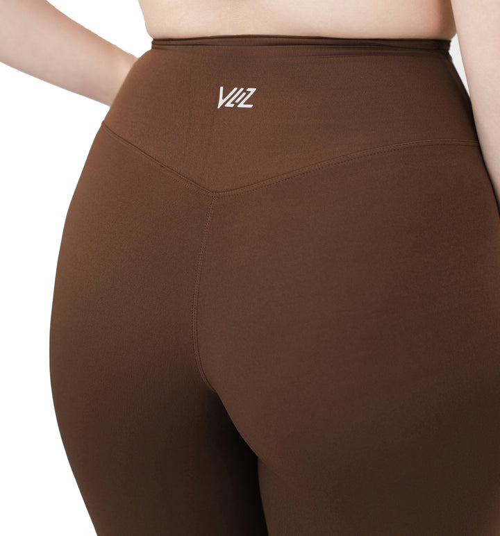 Close-up back view of VLIZ Ultra Soft SculptFit Mid-Length Legging Shorts in chestnut brown, featuring a V-shaped seam and the VLIZ logo at the waistband.