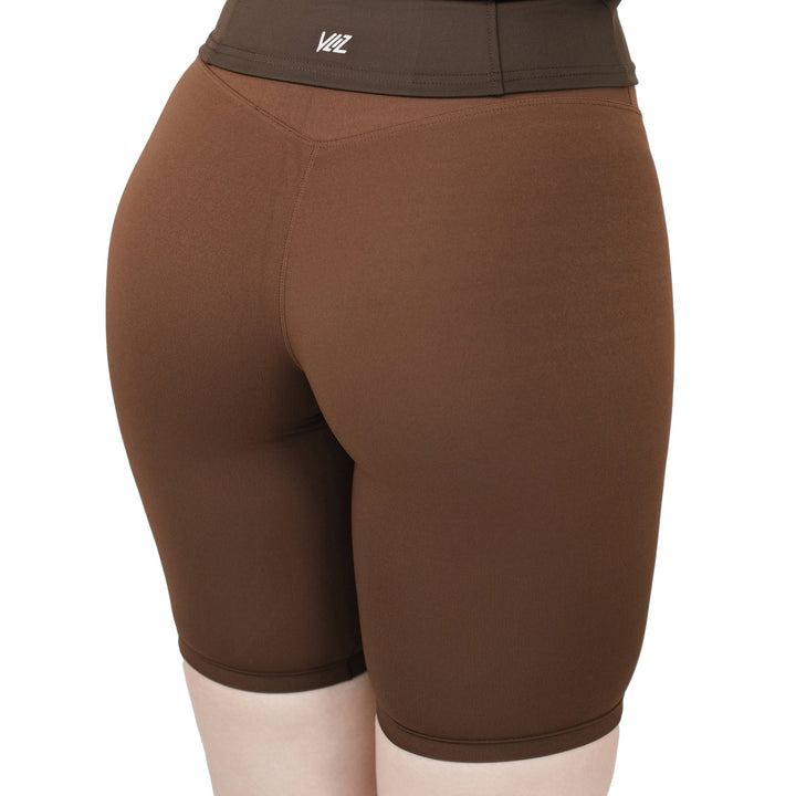 Back view of VLIZ Ultra Soft SculptFit Mid-Length Legging Shorts in Chestnut Brown, featuring high-waist support, seamless construction, and a body-contouring fit designed for stretch and comfort.