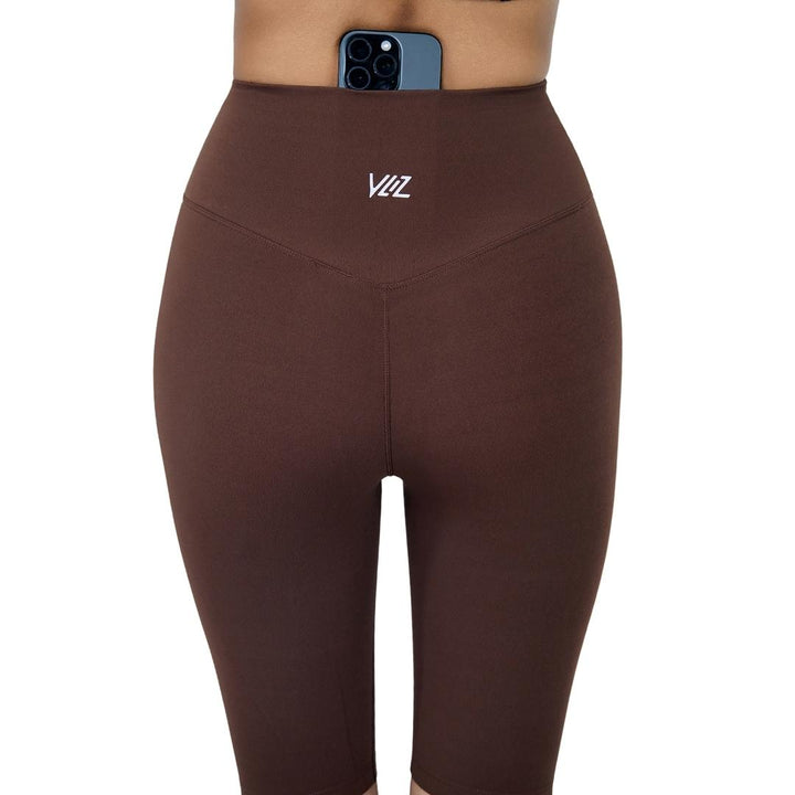 VLIZ Ultra Soft SculptFit Mid-Length Legging Shorts in Chestnut Brown/chocolate brown, featuring a high waist, breathable four-way stretch nylon fabric, a hidden phone pocket at the inner back waistband, and an above-the-knee length ideal for yoga and gym training.