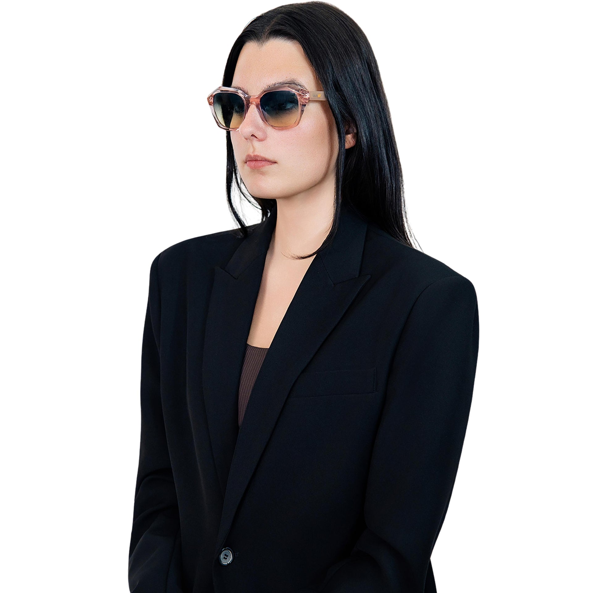 Model wearing VLIZ Altara sunglasses with a translucent pink-gradient frame and blue lenses, paired with a taupe sports tank and denim jeans, showing a soft yet modern unisex aesthetic with UV400 lens protection.
