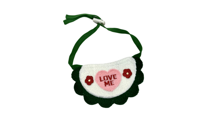 Green knitted pet bandana with a 3D texture, featuring an adjustable tie-up design and embroidered "LOVE me" text for a cute and cozy look.