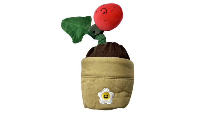 Plush strawberry potted dog toy with removable parts, built-in squeakers, and a treat-hiding feature for interactive and engaging play.