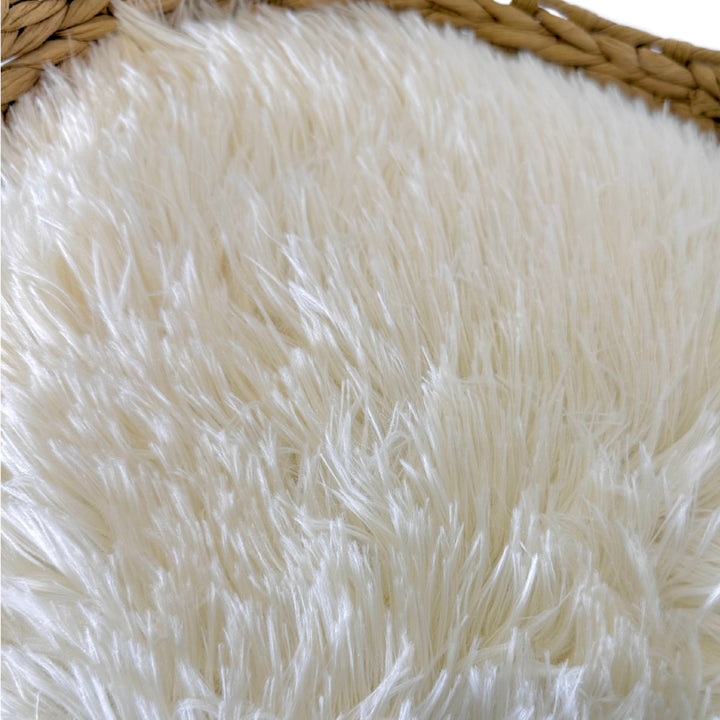 Close-up of ultra-soft ivory faux fur cushion on a woven cat tree bed, designed for cozy pet lounging