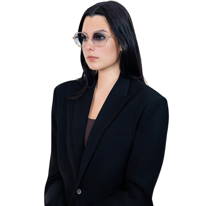 VLIZ Lunelle sunglasses with a translucent tea octagon frame and light blue gradient lenses, sculptural silhouette inspired by lunar geometry, engraved logo on temples