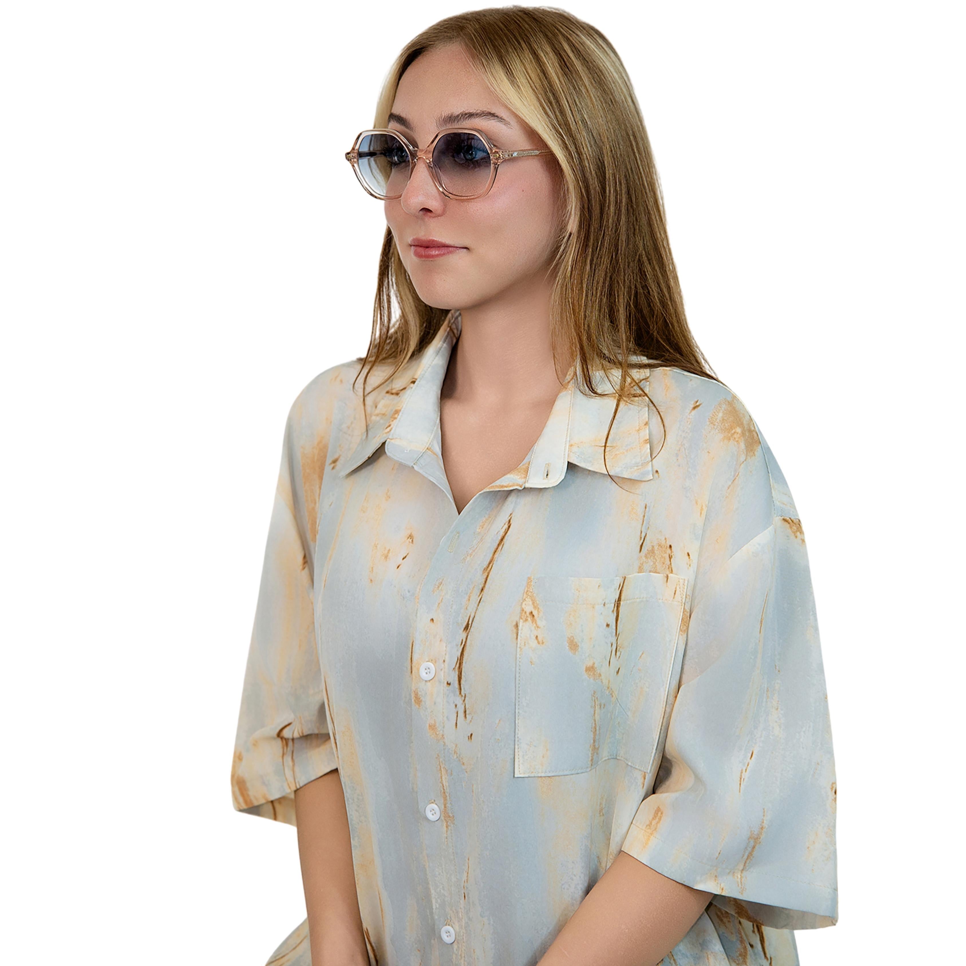 VLIZ Lunelle sunglasses with a translucent tea octagon frame and light blue gradient lenses, sculptural silhouette inspired by lunar geometry, engraved logo on temples