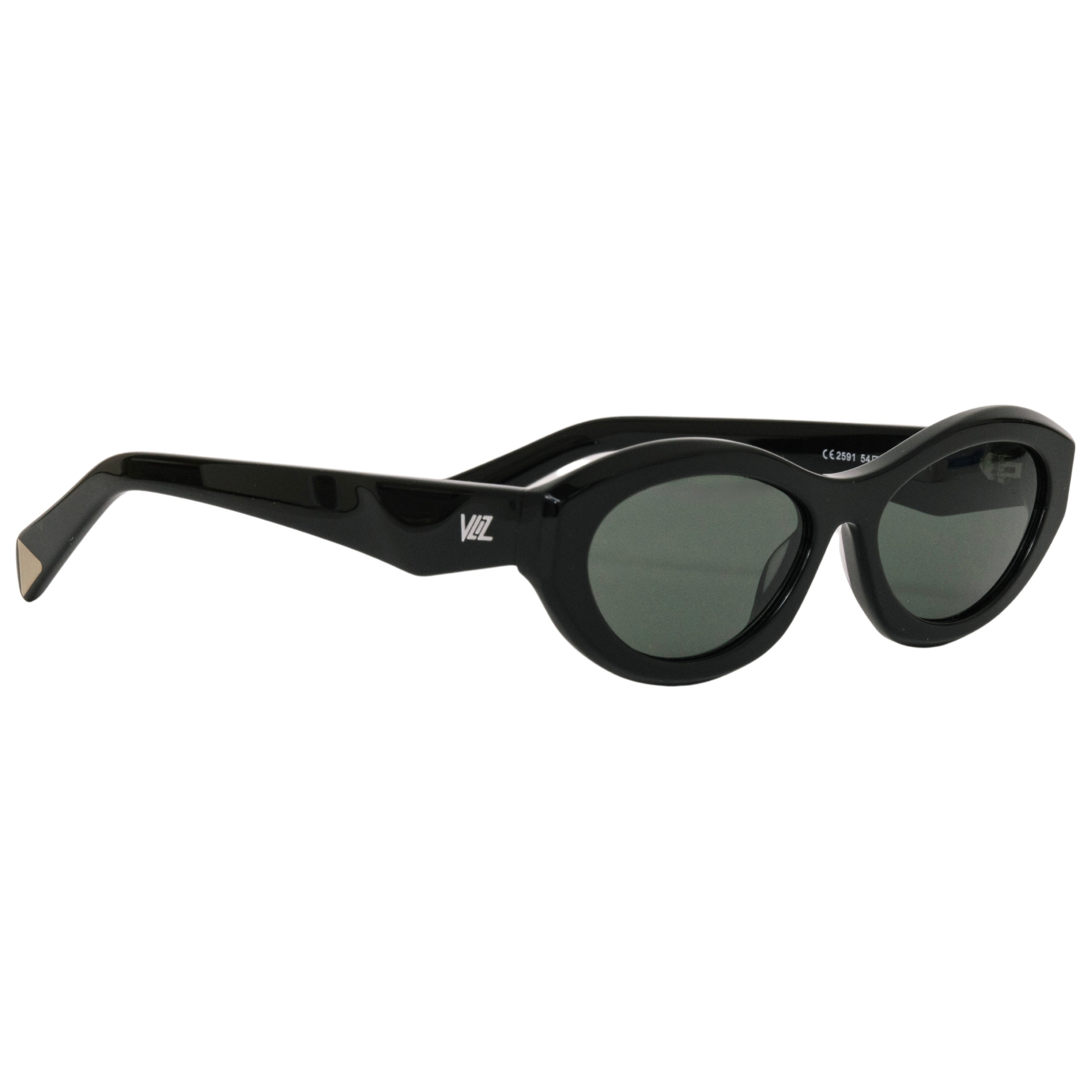 VLIZ Nolita oval sunglasses with black frame and black lenses, featuring smooth oval design and engraved logo on temples.
