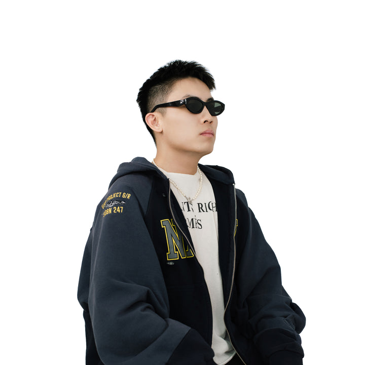 VLIZ Nolita oval sunglasses with black frame and black lenses, featuring smooth oval design and engraved logo on temples.
