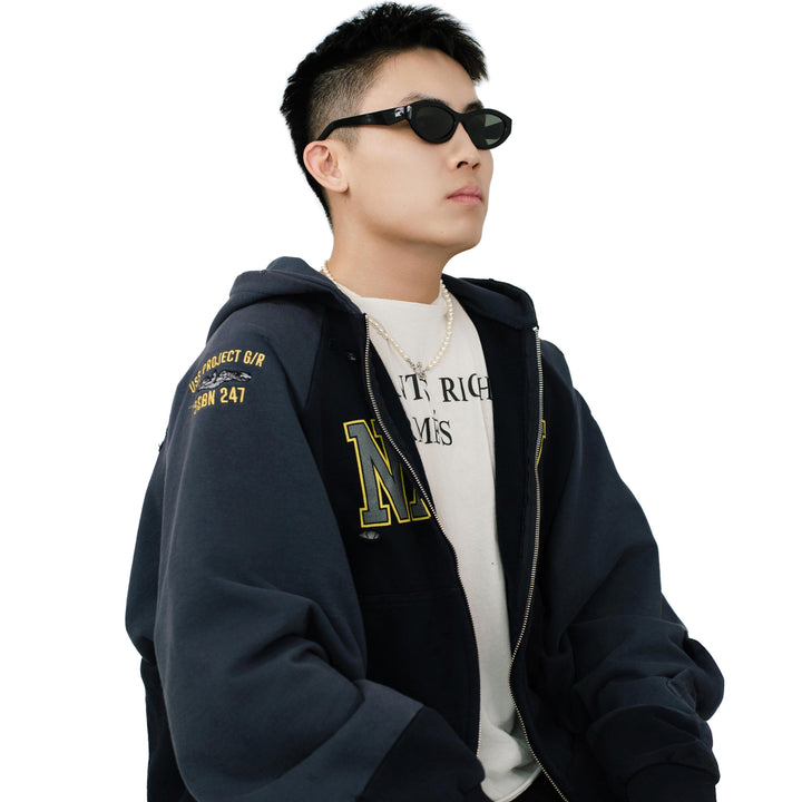VLIZ Nolita oval sunglasses with black frame and black lenses, featuring smooth oval design and engraved logo on temples.