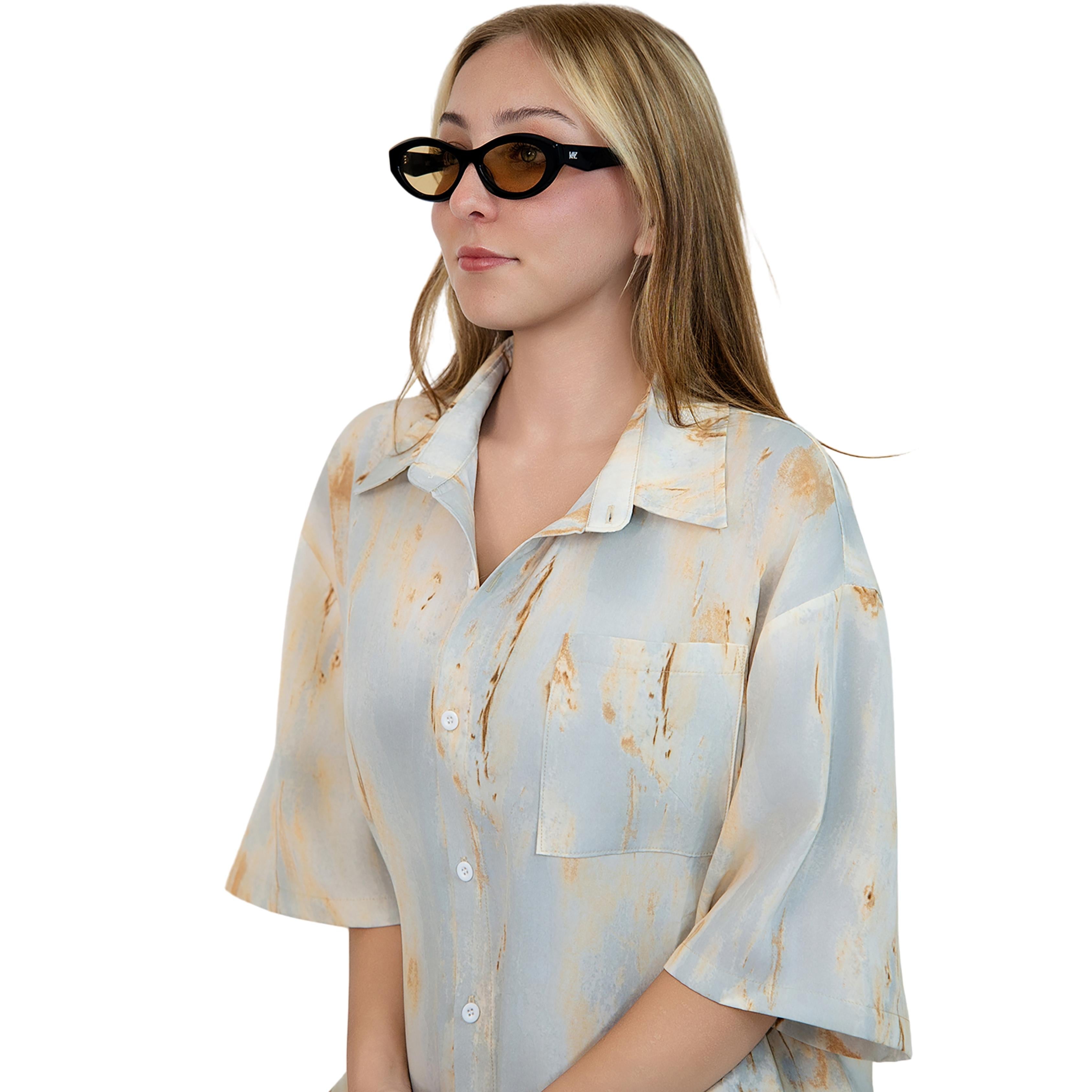 VLIZ Nolita oval sunglasses with black frame and brown lenses, featuring smooth oval design and engraved logo on temples.