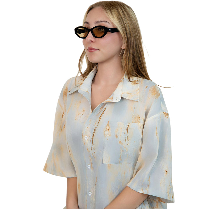 VLIZ Nolita oval sunglasses with black frame and brown lenses, featuring smooth oval design and engraved logo on temples.