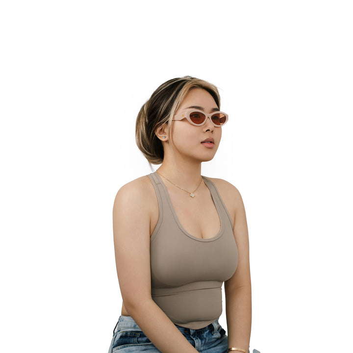 VLIZ Nolita oval sunglasses with pink frame and pink lenses, featuring smooth oval design and engraved logo on temples.