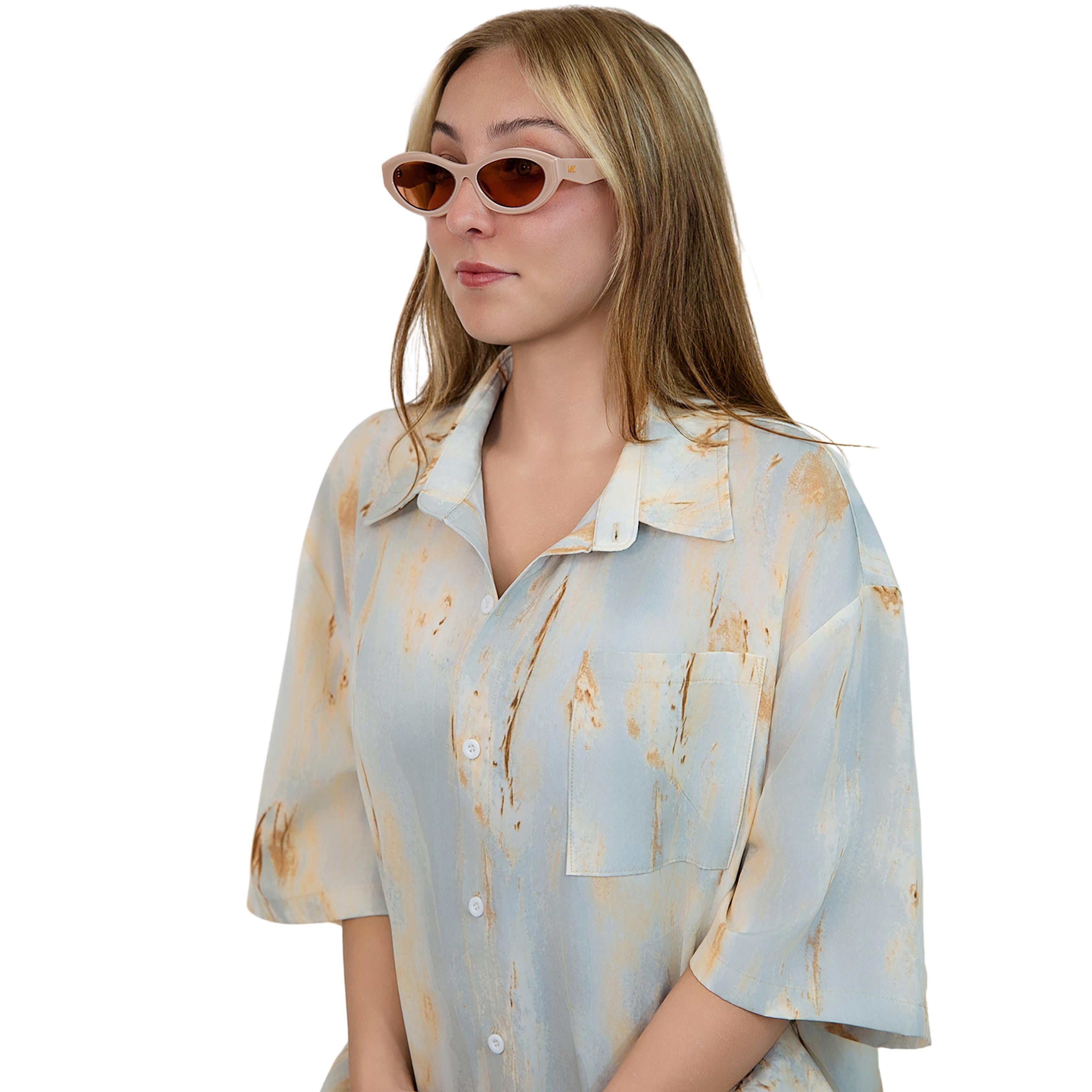 VLIZ Nolita oval sunglasses with pink frame and pink lenses, featuring smooth oval design and engraved logo on temples.