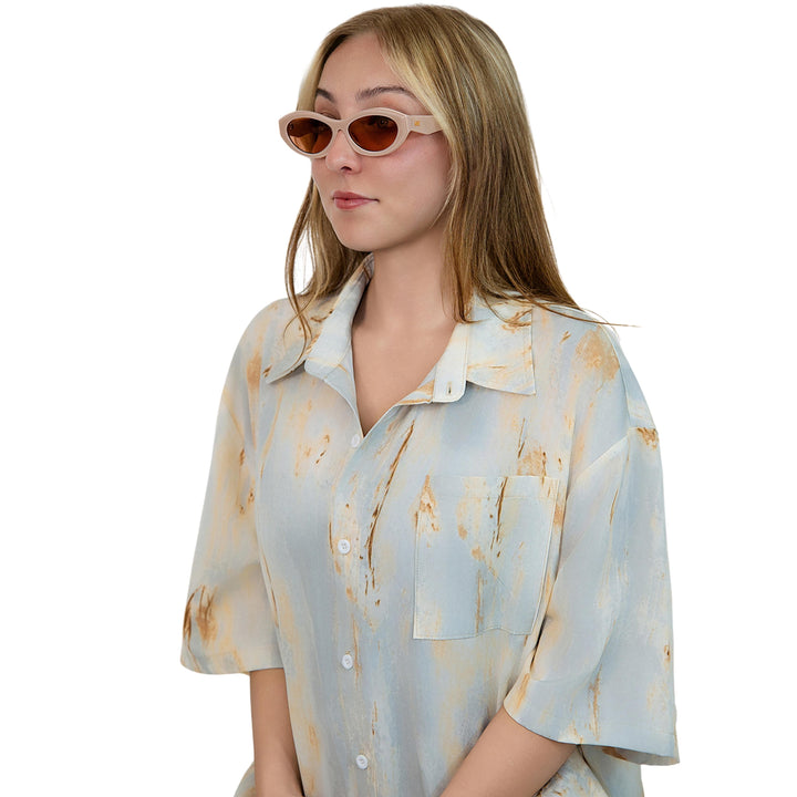 VLIZ Nolita oval sunglasses with pink frame and pink lenses, featuring smooth oval design and engraved logo on temples.