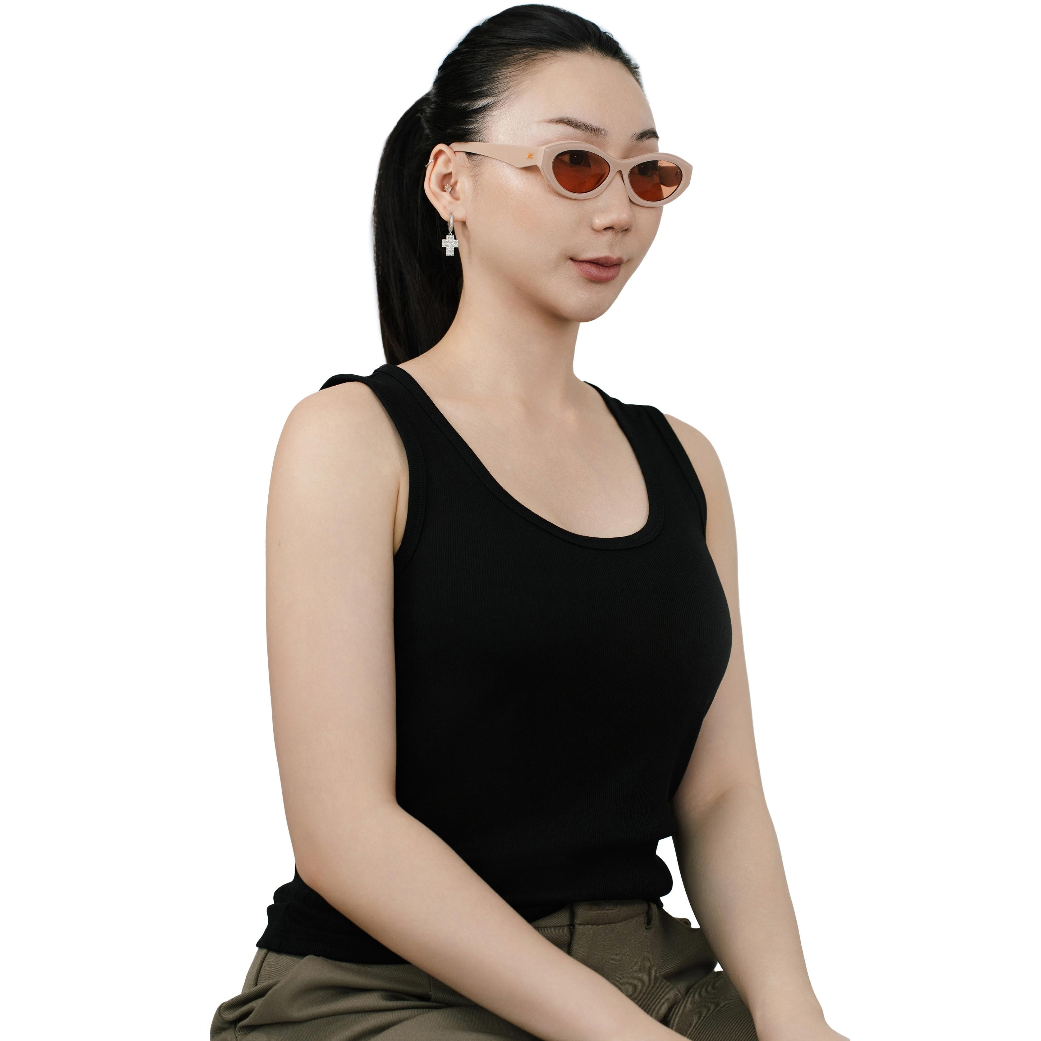 VLIZ Nolita oval sunglasses with pink frame and pink lenses, featuring smooth oval design and engraved logo on temples.