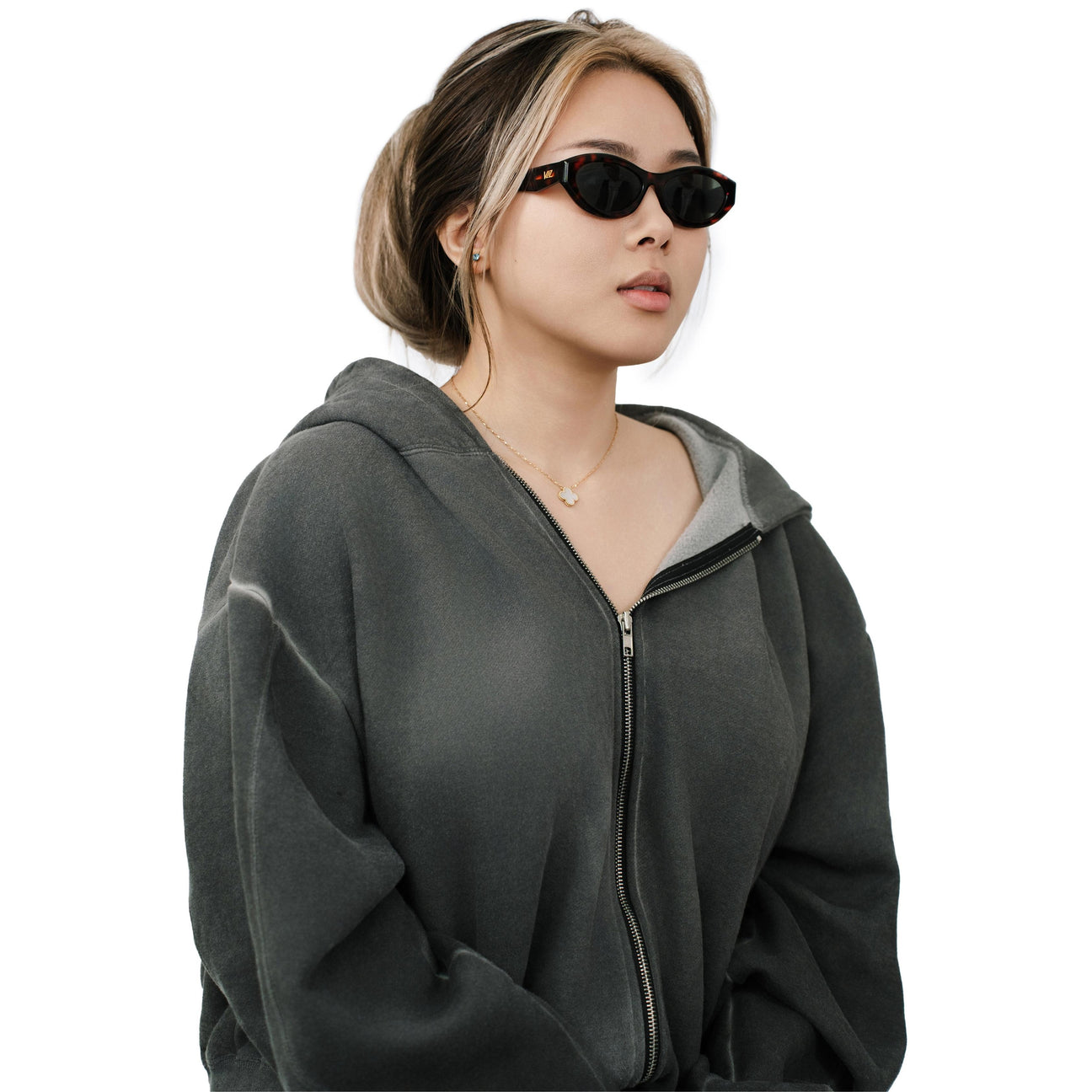 VLIZ Nolita oval sunglasses with tortoise frame and black lenses, featuring smooth oval design and engraved logo on temples.