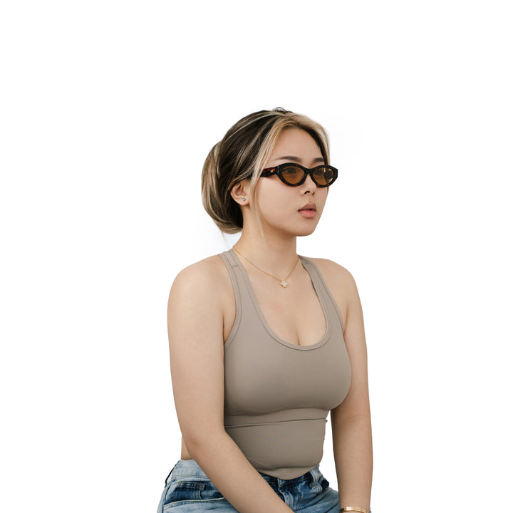 VLIZ Nolita oval sunglasses with tortoise frame and brown lenses, featuring smooth oval design and engraved logo on temples.