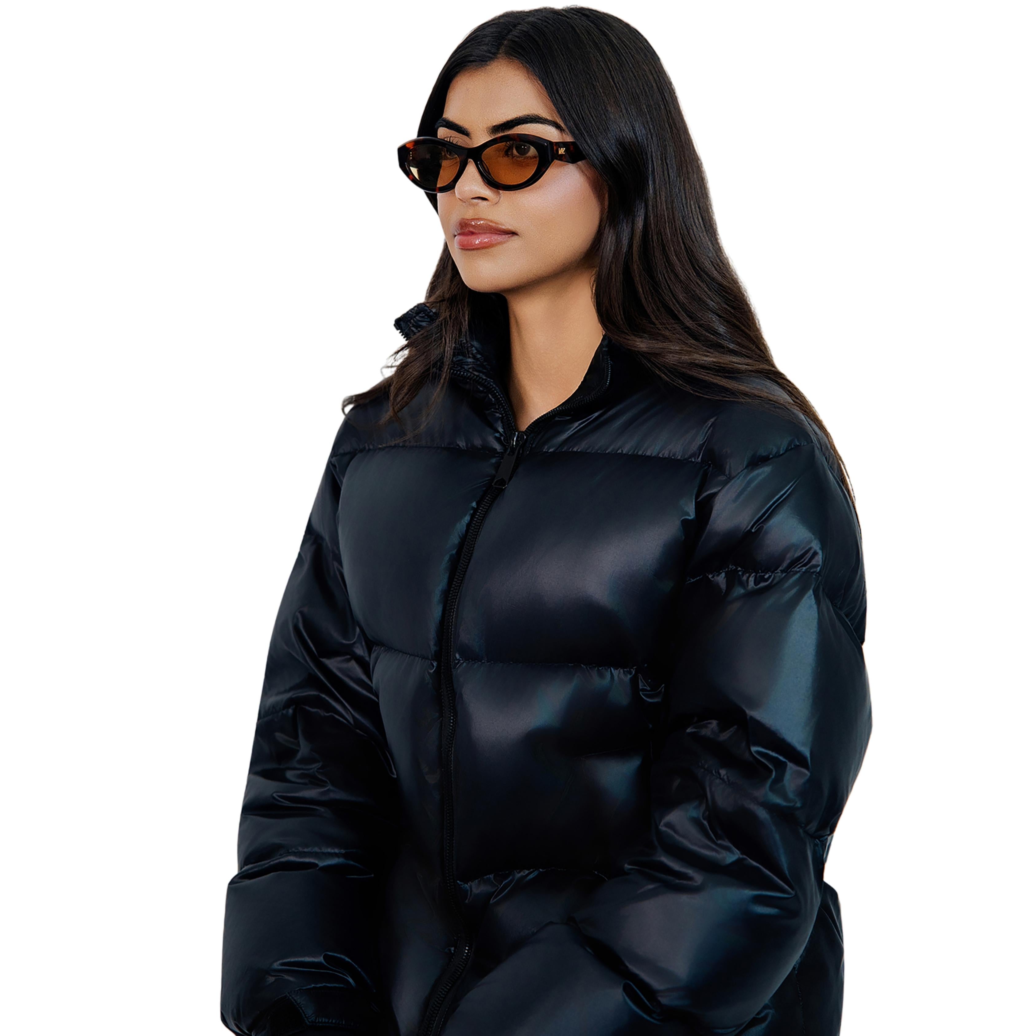 VLIZ Nolita oval sunglasses with tortoise frame and brown lenses, featuring smooth oval design and engraved logo on temples.