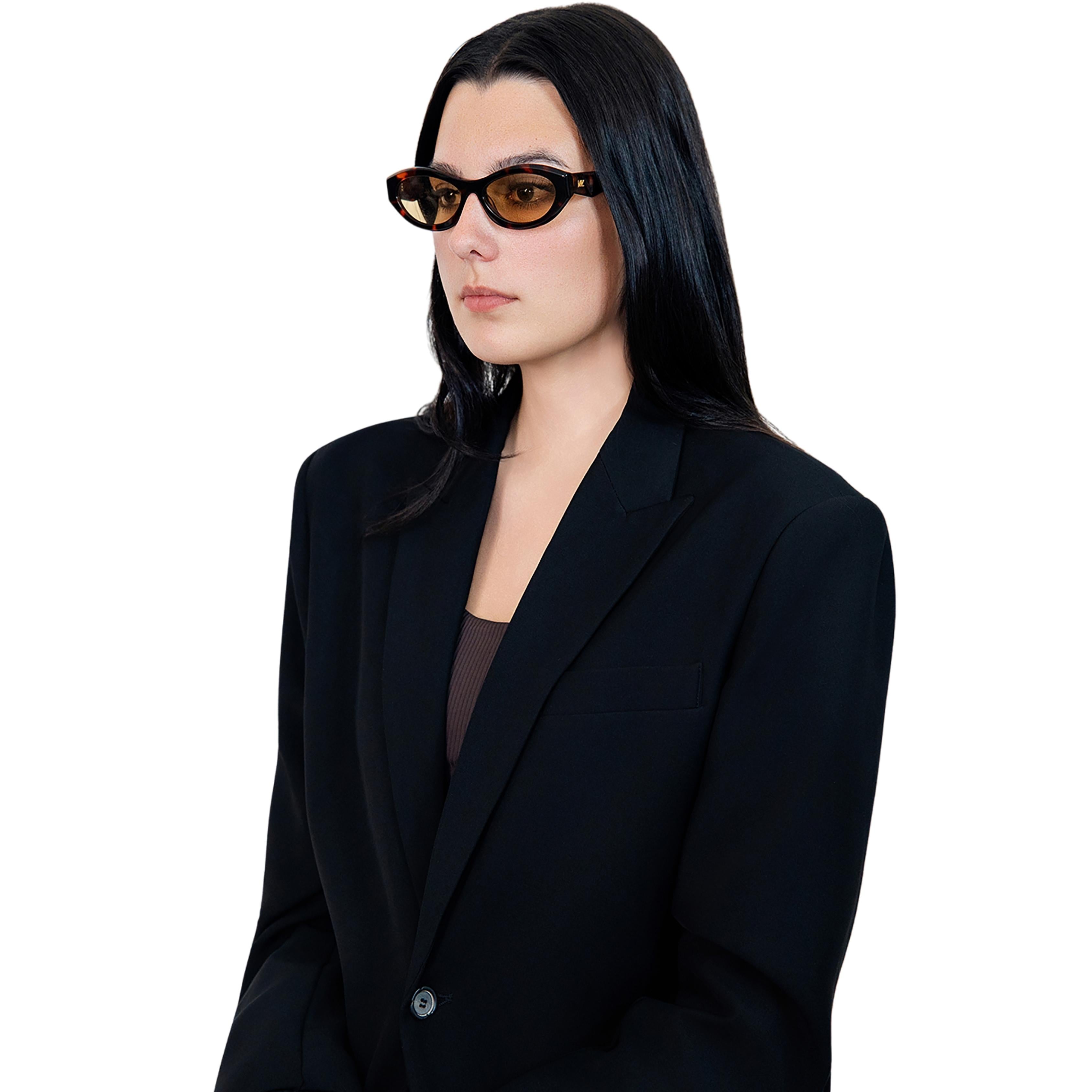 VLIZ Nolita oval sunglasses with tortoise frame and brown lenses, featuring smooth oval design and engraved logo on temples.