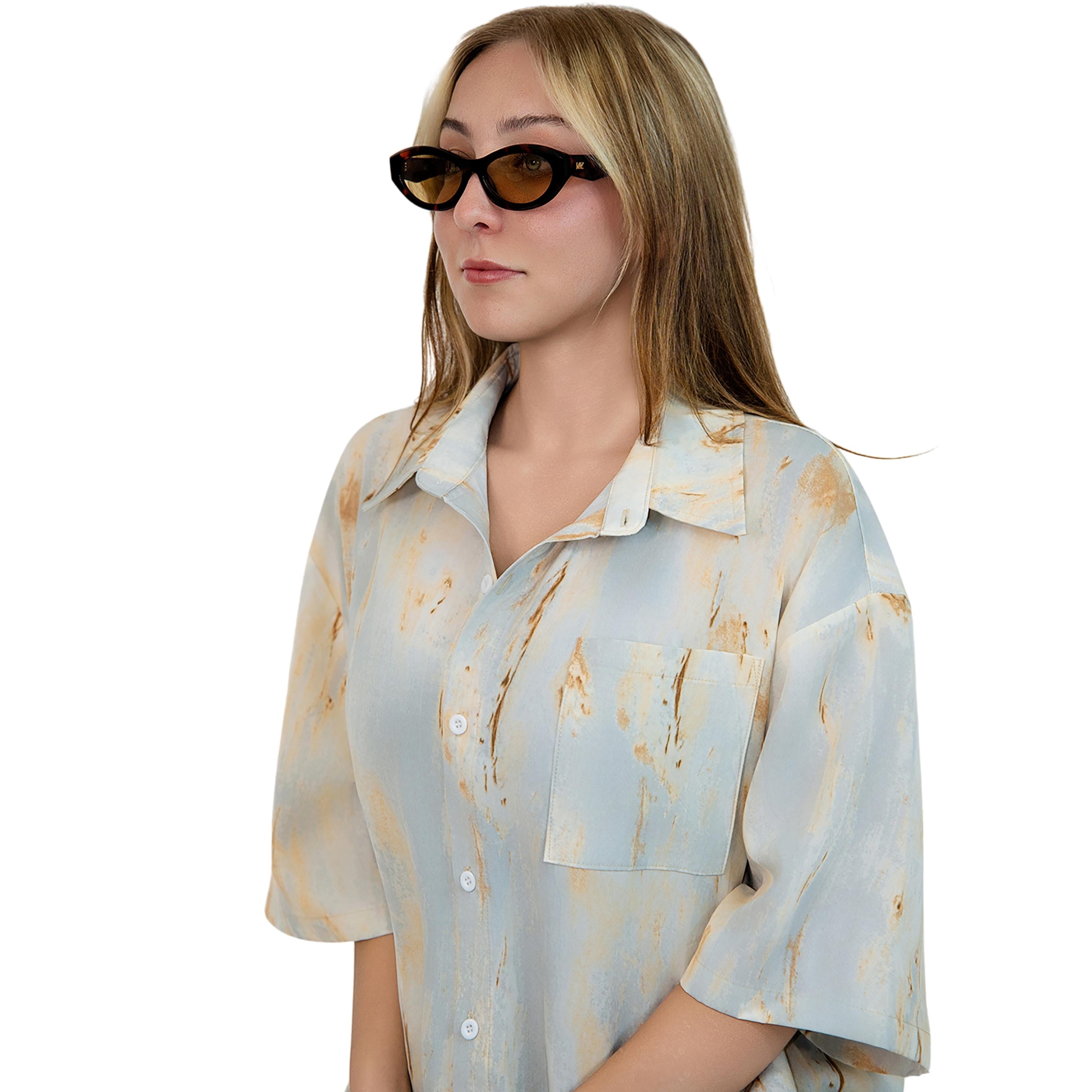 VLIZ Nolita oval sunglasses with tortoise frame and brown lenses, featuring smooth oval design and engraved logo on temples.