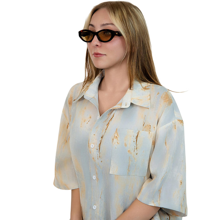 VLIZ Nolita oval sunglasses with tortoise frame and brown lenses, featuring smooth oval design and engraved logo on temples.
