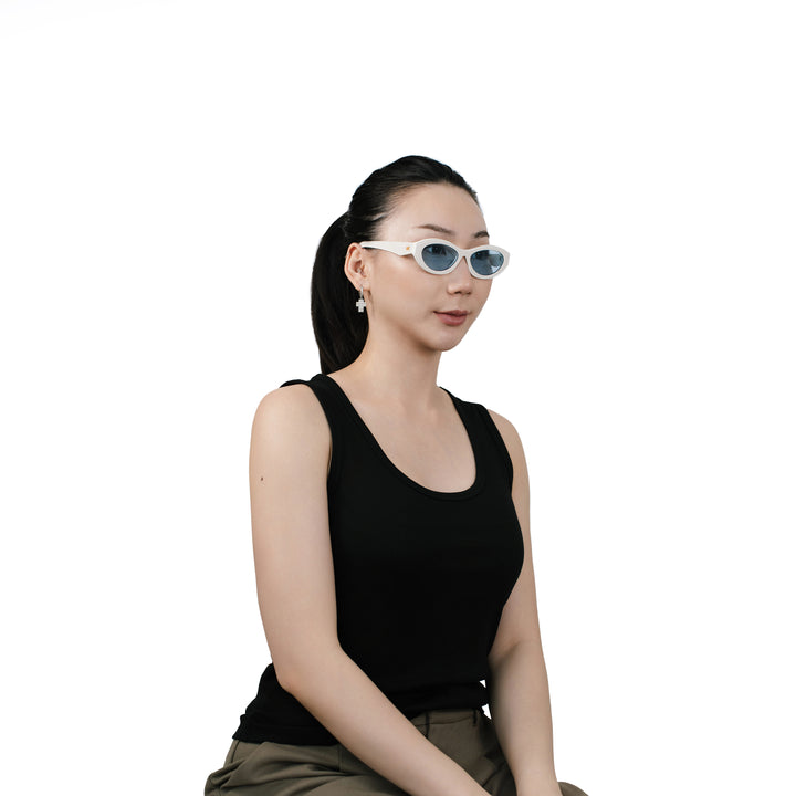 VLIZ Nolita oval sunglasses with white frame and blue lenses, featuring smooth oval design and engraved logo on temples.