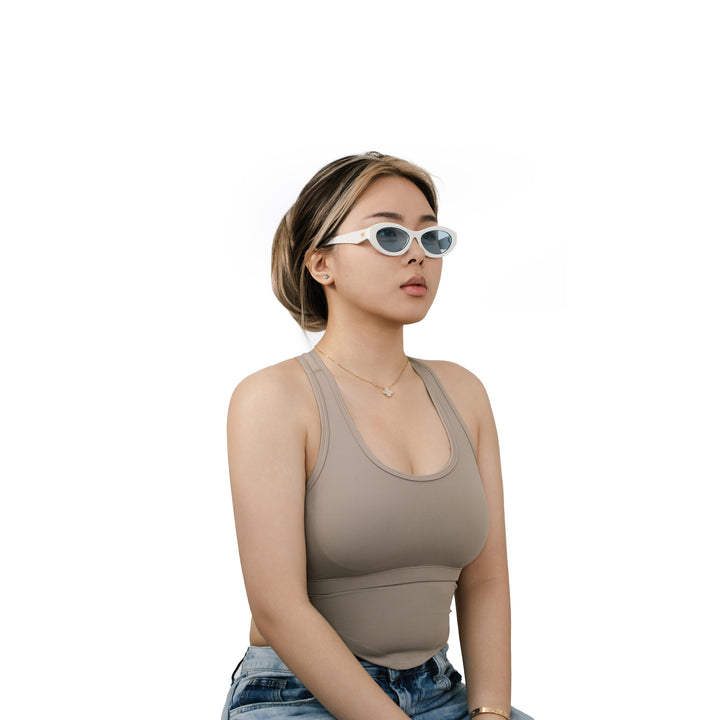 VLIZ Nolita oval sunglasses with white frame and blue lenses, featuring smooth oval design and engraved logo on temples.