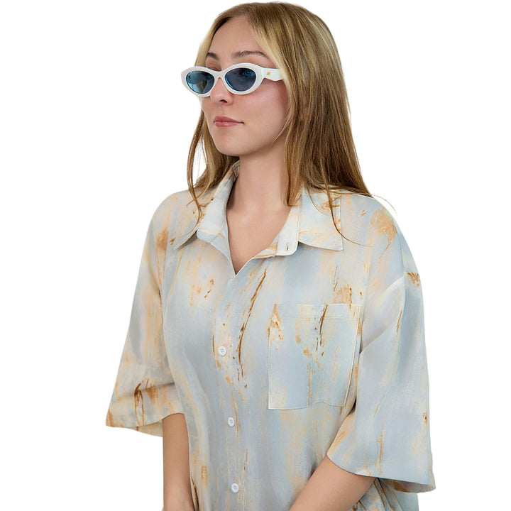VLIZ Nolita oval sunglasses with white frame and blue lenses, featuring smooth oval design and engraved logo on temples.