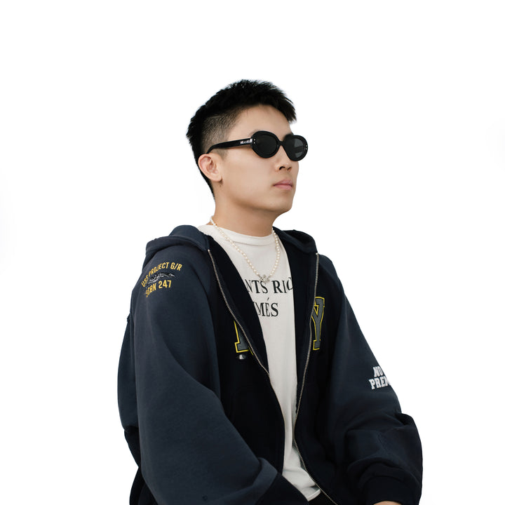 VLIZ Oracle sunglasses with a black wide oval frame, black lenses, retro styling, and engraved logo on temples.