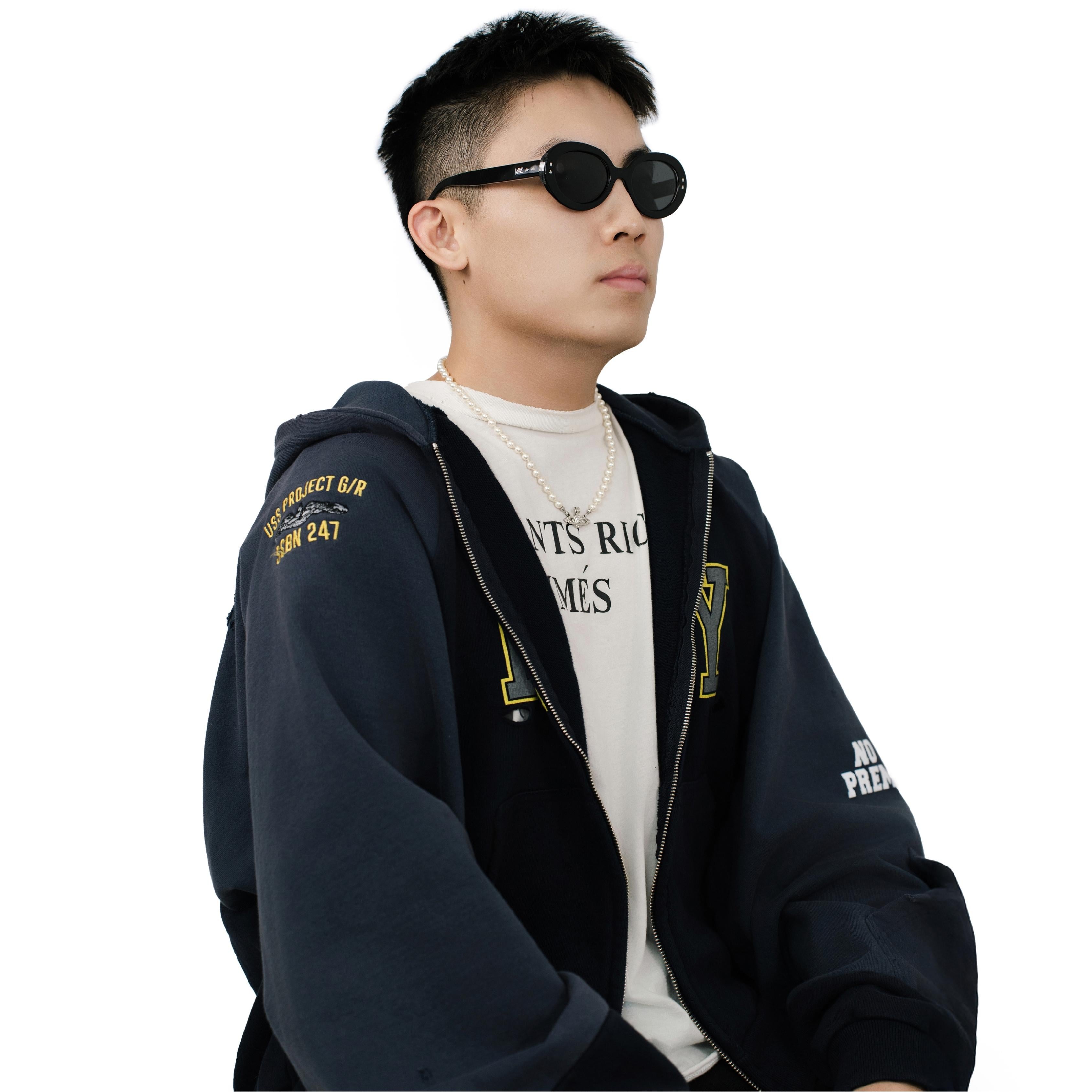 VLIZ Oracle sunglasses with a black wide oval frame, black lenses, retro styling, and engraved logo on temples.
