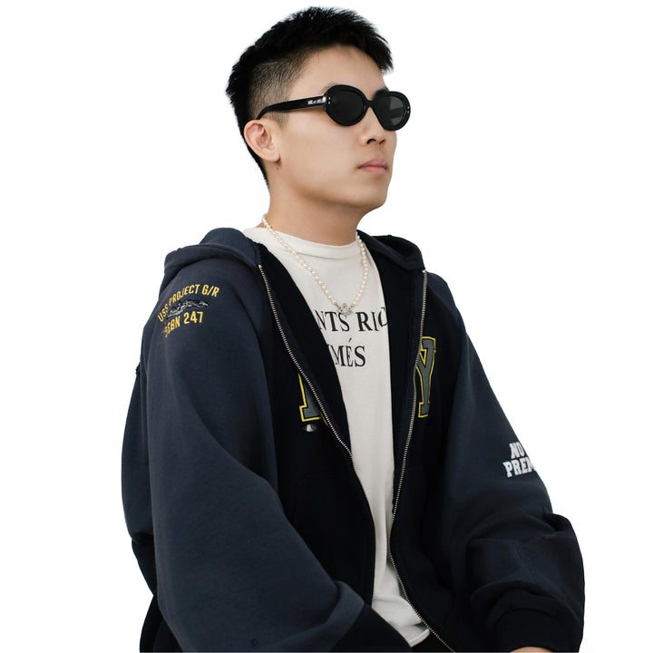 VLIZ Oracle sunglasses with a black wide oval frame, black lenses, retro styling, and engraved logo on temples.