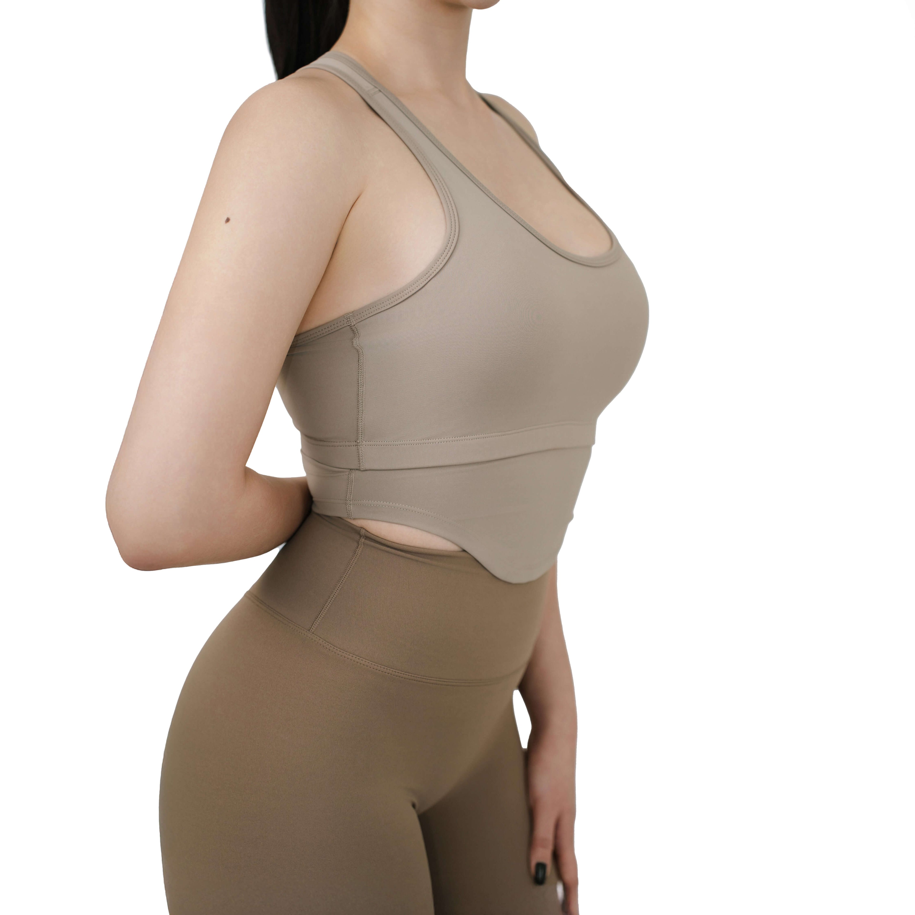 Close-up side view of VLIZ SculptFit Racerback Sports Bra in khaki, highlighting fabric texture, seam detail, and underbust cutout.