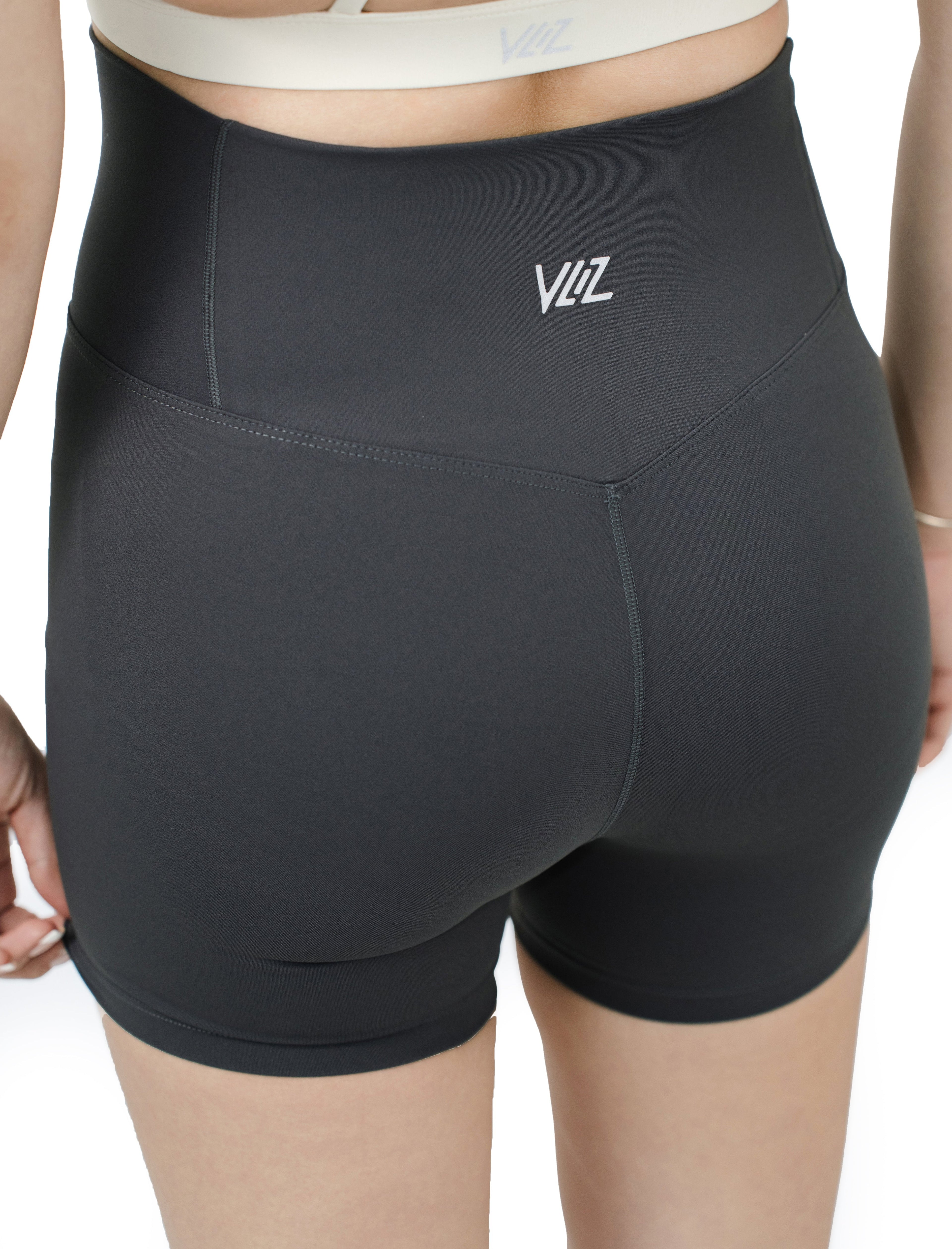 Close-up back view of VLIZ Ultra Soft SculptFit Short Leggings in Gray, featuring sculpted seam lines, high-rise waistband, and rear logo detailing.